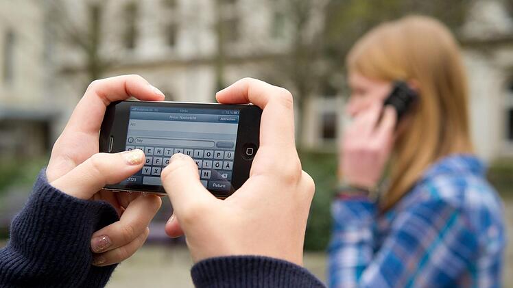 SMS schreiben und telefonieren auf dem Schulhof? Es gibt Befürworter und Gegner gleichermaßen.  Sebastian Kahnert/dpa